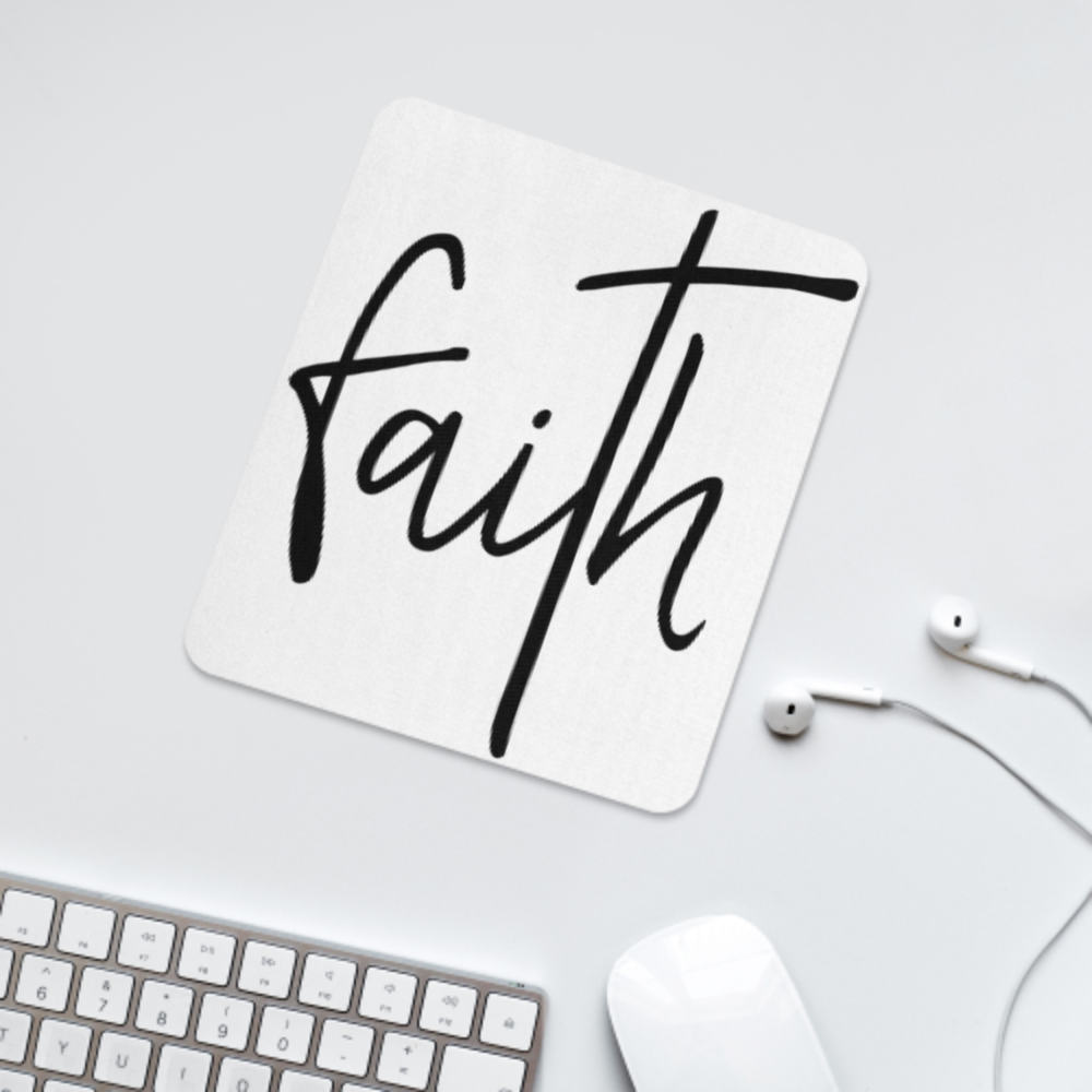 White mouse pad or coaster with 'faith' printed on it, placed on a desk with a keyboard and mouse.